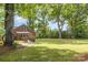 Spacious backyard showcasing a well-maintained lawn, mature trees, and the home's exterior at 1400 Matheson Ave, Charlotte, NC 28205
