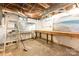 Unfinished basement with exposed pipes, windows, tables, beach themed art and painted cinder block walls at 1400 Matheson Ave, Charlotte, NC 28205