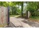 Gated driveway entrance leading to lush landscaping and a private estate at 1400 Matheson Ave, Charlotte, NC 28205