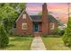 Charming brick home with a striking blue front door and a well-manicured lawn at 1400 Matheson Ave, Charlotte, NC 28205