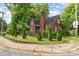 All-brick house featuring a well-kept lawn, tall trees, and a classic architectural style at 1400 Matheson Ave, Charlotte, NC 28205