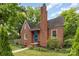 Traditional brick home with a cozy front yard, featuring a blue door, and lush greenery at 1400 Matheson Ave, Charlotte, NC 28205