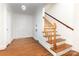 Traditional hallway features wood flooring, stairs with wood railing, and white trim at 1400 Matheson Ave, Charlotte, NC 28205