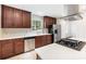 Bright kitchen featuring stainless steel appliances, white countertops, and dark wood cabinets at 1400 Matheson Ave, Charlotte, NC 28205