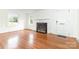 Spacious living room featuring a fireplace, hardwood floors, and natural light from large windows at 1400 Matheson Ave, Charlotte, NC 28205