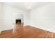 Elegant living room with hardwood floors, white walls, and an archway leading to a fireplace at 1400 Matheson Ave, Charlotte, NC 28205
