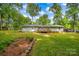 The backyard features a lush lawn, mature trees, a wooden deck, and a fenced perimeter at 144 Stoneybrook Rd, Salisbury, NC 28147