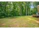 The expansive backyard includes mature trees, a lush green lawn, and a wood deck at 144 Stoneybrook Rd, Salisbury, NC 28147