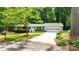Charming single-story home with a well-manicured lawn, mature trees, and an attached two-car garage at 144 Stoneybrook Rd, Salisbury, NC 28147