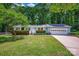 Charming single-story home with a well-manicured lawn, mature trees, and an attached two-car garage at 144 Stoneybrook Rd, Salisbury, NC 28147