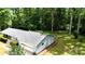 Aerial view of this home's exterior featuring a lush, green lawn, mature trees, and attached garage at 144 Stoneybrook Rd, Salisbury, NC 28147