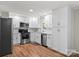 Updated kitchen with stainless steel appliances, white cabinets, subway tile backsplash, and wood grain floors at 144 Stoneybrook Rd, Salisbury, NC 28147