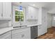 Bright kitchen features white cabinets, subway tile backsplash, stainless steel appliances, and quartz countertops at 144 Stoneybrook Rd, Salisbury, NC 28147