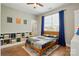 Bright bedroom features hardwood floors, a ceiling fan, and a window with blue curtains at 1478 Imperial Ct, York, SC 29745