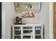 Coffee bar nook has mugs, glassware, decorative painting and open shelving in a bright space at 1478 Imperial Ct, York, SC 29745