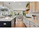 Open kitchen has an island with bar stool seating that looks into the dining area and sunroom at 1478 Imperial Ct, York, SC 29745