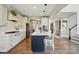 Open kitchen with island seating features stainless appliances, white cabinetry, and modern pendant lighting at 1478 Imperial Ct, York, SC 29745