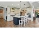Stylish kitchen features a dark island, white cabinets, stainless appliances, and modern pendant lighting at 1478 Imperial Ct, York, SC 29745
