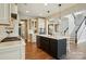 Modern kitchen with stainless appliances features an island with bar seating, and light wood flooring at 1478 Imperial Ct, York, SC 29745