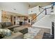 Open-concept living room leads to a modern kitchen, featuring a beautiful staircase and lots of space at 1478 Imperial Ct, York, SC 29745