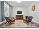 Comfortable living room with modern decor, a cozy fireplace, and large windows for natural light at 1478 Imperial Ct, York, SC 29745