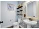 Charming powder room features floral wallpaper, decorative shelves, and a pedestal sink with modern fixtures at 1478 Imperial Ct, York, SC 29745