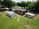 Aerial view of backyard featuring outbuildings, level lawn, and mature trees at 1585 Salem Church Rd, Lincolnton, NC 28092