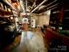 Unfinished basement area with exposed utilities, storage shelves, and a water heater at 1585 Salem Church Rd, Lincolnton, NC 28092