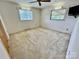 Bedroom featuring neutral colored carpet, two windows, and a ceiling fan at 1585 Salem Church Rd, Lincolnton, NC 28092