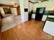 View of kitchen with hardwood flooring and adjacent carpeted living room at 1585 Salem Church Rd, Lincolnton, NC 28092