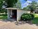 Outdoor storage shed with open side for easy access, surrounded by lush greenery in a residential area at 1585 Salem Church Rd, Lincolnton, NC 28092