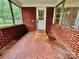 Enclosed sunroom featuring brick construction and tiled flooring at 1585 Salem Church Rd, Lincolnton, NC 28092