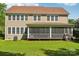 Tan two-story home featuring a spacious screened-in porch and a well-maintained lawn at 1805 Sutter Creek Dr, Waxhaw, NC 28173