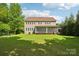Exterior view of the home with a large screened-in porch and expansive lawn, perfect for entertaining at 1805 Sutter Creek Dr, Waxhaw, NC 28173
