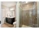 Full bathroom with tiled shower and a vanity with a dark cabinet, toilet, and mirror at 1805 Sutter Creek Dr, Waxhaw, NC 28173