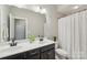Bathroom featuring double vanity, framed mirror, and shower with curtain at 1805 Sutter Creek Dr, Waxhaw, NC 28173