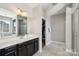 Bathroom featuring double sinks, walk-in closet, a soaking tub, and a tiled glass shower at 1805 Sutter Creek Dr, Waxhaw, NC 28173
