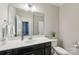 Half bathroom features a modern sink and cabinet with toilet and towel rack, ready for guests at 1805 Sutter Creek Dr, Waxhaw, NC 28173