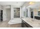 Spacious bathroom with a soaking tub, glass shower, and double sinks offering plenty of counter space at 1805 Sutter Creek Dr, Waxhaw, NC 28173