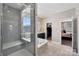 Luxurious bathroom featuring a glass shower, a soaking tub, and a view to the bedroom at 1805 Sutter Creek Dr, Waxhaw, NC 28173