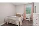 Charming bedroom with a white bed frame, pink accents, and window views at 1805 Sutter Creek Dr, Waxhaw, NC 28173
