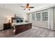 Comfortable bedroom showcasing large windows, a ceiling fan, and a spacious layout at 1805 Sutter Creek Dr, Waxhaw, NC 28173