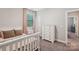 Light-filled bedroom with a white bed, dresser and window with pink curtains at 1805 Sutter Creek Dr, Waxhaw, NC 28173