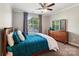 Cozy bedroom features plush carpet, ceiling fan, and window with decorative curtains for a relaxing retreat at 1805 Sutter Creek Dr, Waxhaw, NC 28173