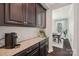 Butler's pantry featuring granite countertop and dark wood cabinets at 1805 Sutter Creek Dr, Waxhaw, NC 28173
