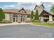 Stone clubhouse featuring arched entryways, lush landscaping, and a welcoming atmosphere at 1805 Sutter Creek Dr, Waxhaw, NC 28173