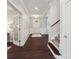 The entryway showcases dark wood flooring, wainscoting, and a stairway leading to the upper level at 1805 Sutter Creek Dr, Waxhaw, NC 28173
