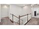 Bright hallway with carpet, white banister and decorative wood trim at 1805 Sutter Creek Dr, Waxhaw, NC 28173