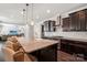 Granite countertops and dark cabinets provide generous storage in the open concept kitchen with island at 1805 Sutter Creek Dr, Waxhaw, NC 28173