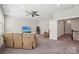Cozy living room with recliner seating, ceiling fan and access to the upper floor at 1805 Sutter Creek Dr, Waxhaw, NC 28173